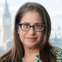 Brunette woman wearing glasses smiling for professional headshot