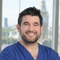 Brunette man with beard smiling for professional headshot