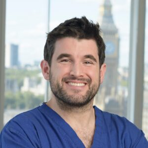 Brunette man with beard smiling for professional headshot