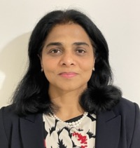 Brunette woman wearing flowery dress and blazer