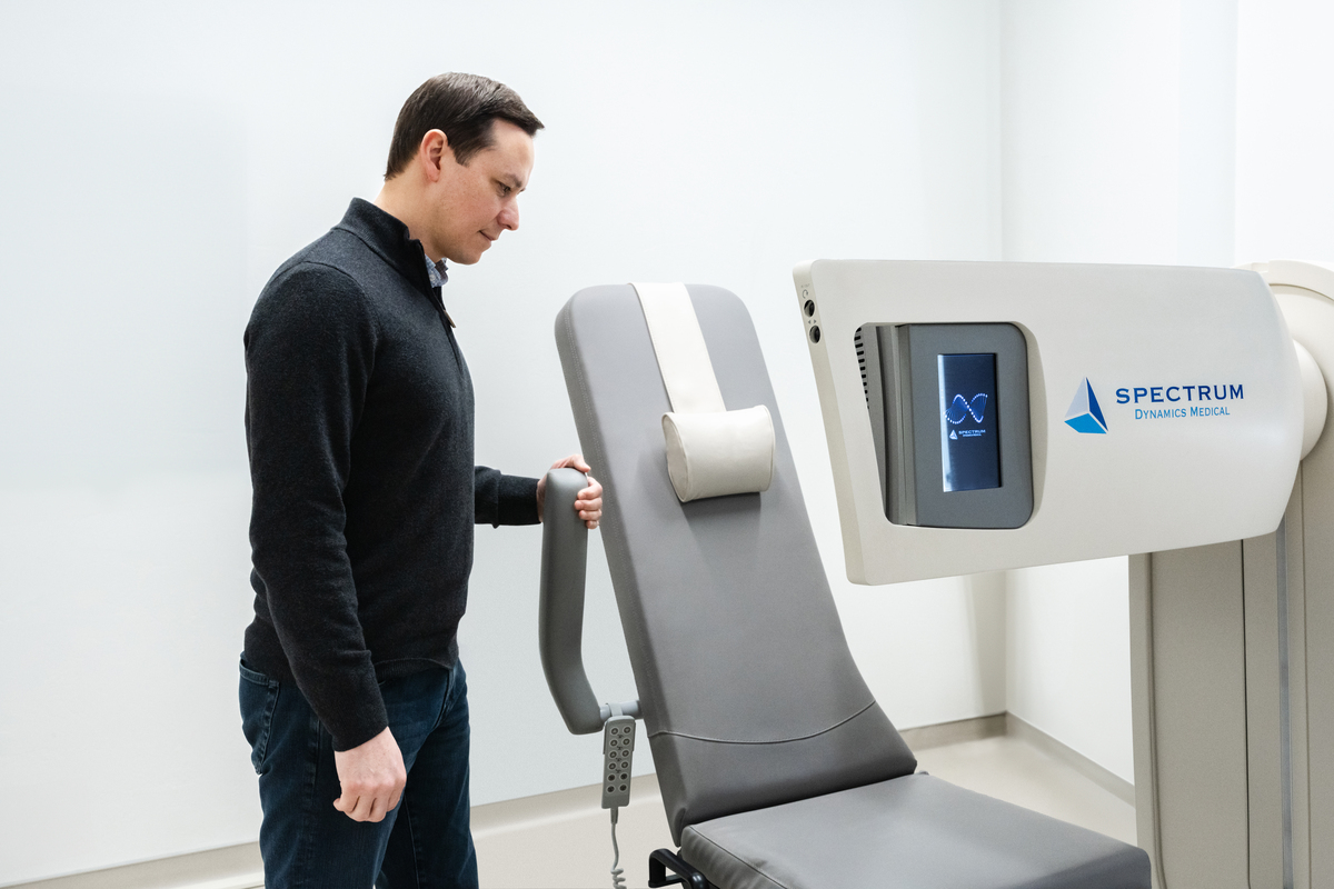 Spectrum Dynamics D-SPECT scanner with seated patient positioning and detector array used for fast cardiac imaging.